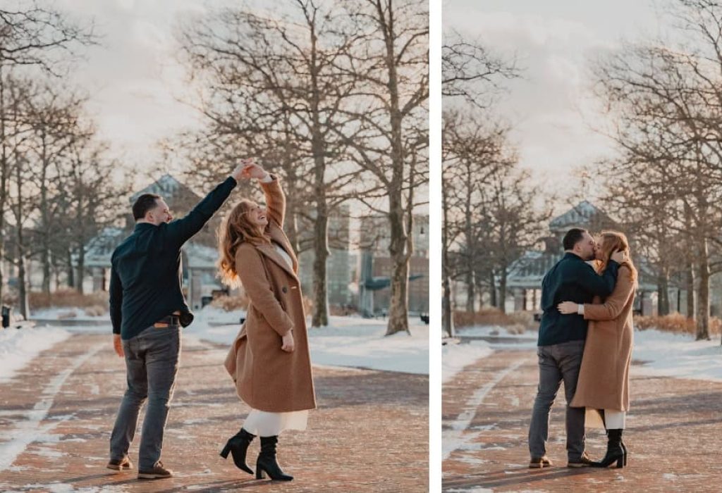 Couple standing by Boston Harbor holding hands and smiling at each other