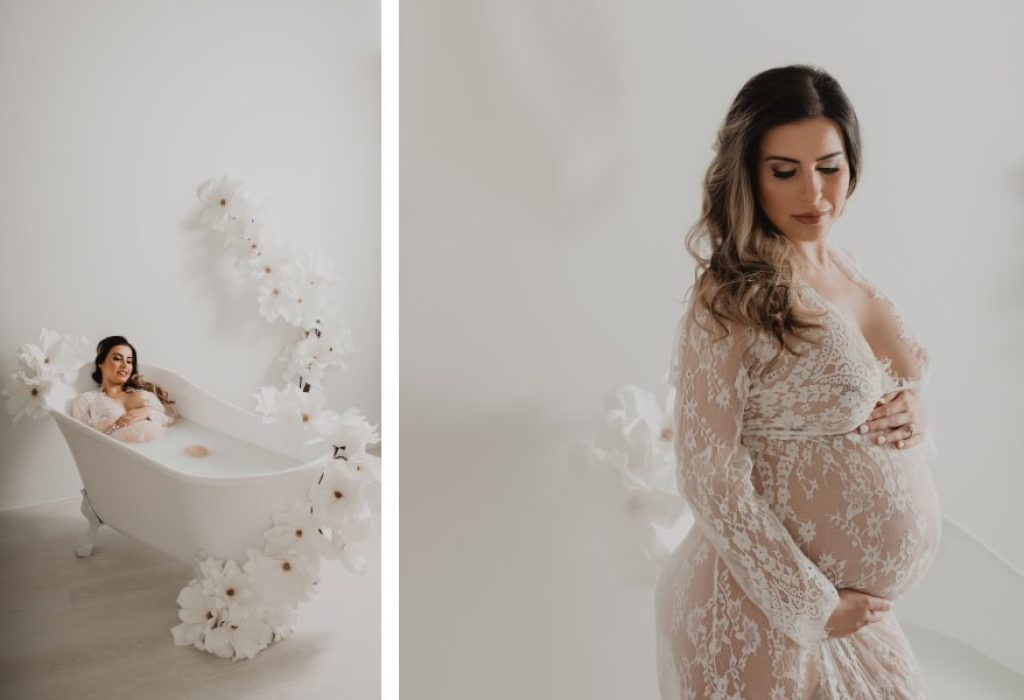 Top view of maternity milk bath with large artificial flowers and expecting mother in lace gown, captured by NH maternity photographer